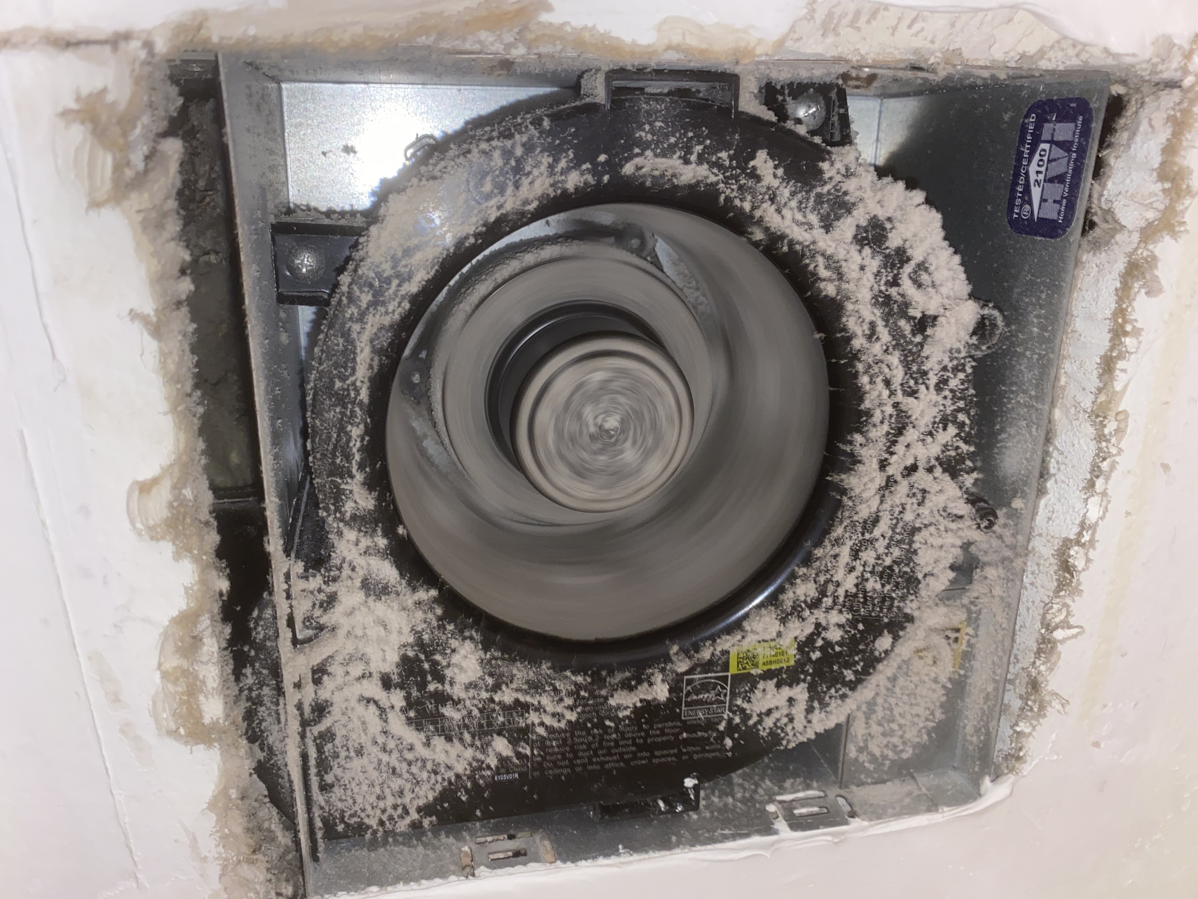 Bathroom exhaust fan with thick dust buildup inside a Bonita Springs home